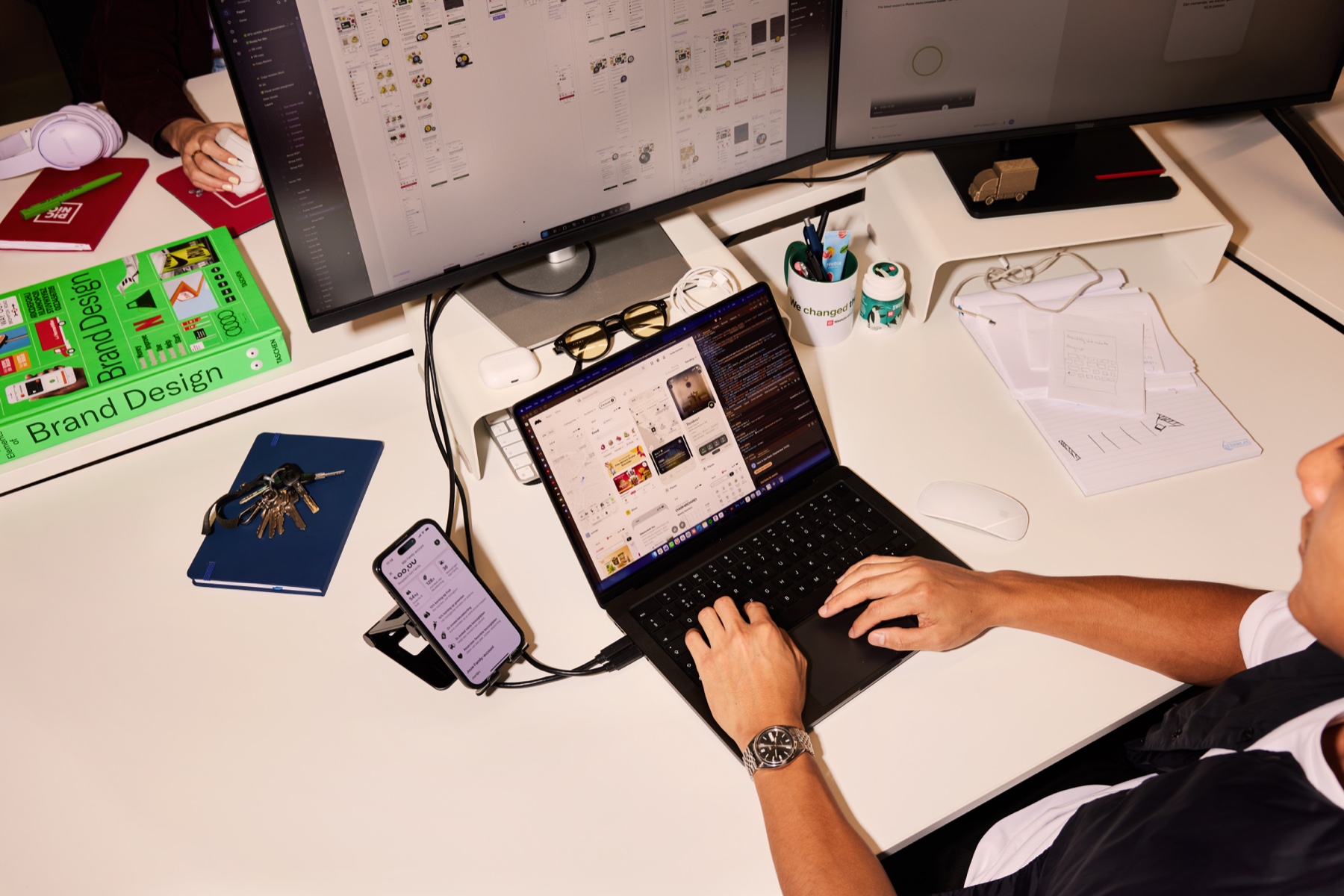 Leslie working at his desk with product designs on screen